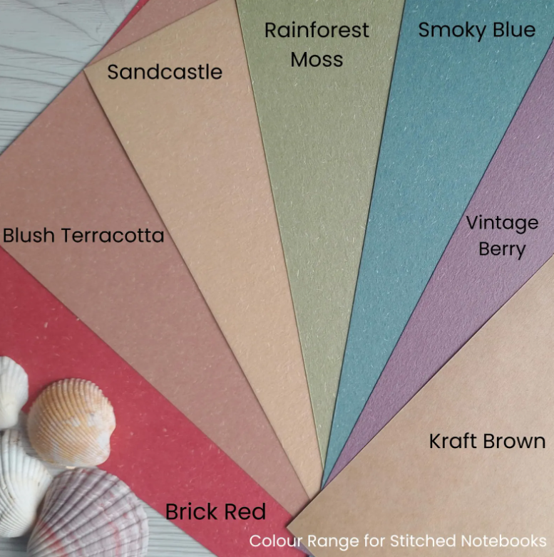 Color swatches for stitched notebooks with shell accents on a textured surface