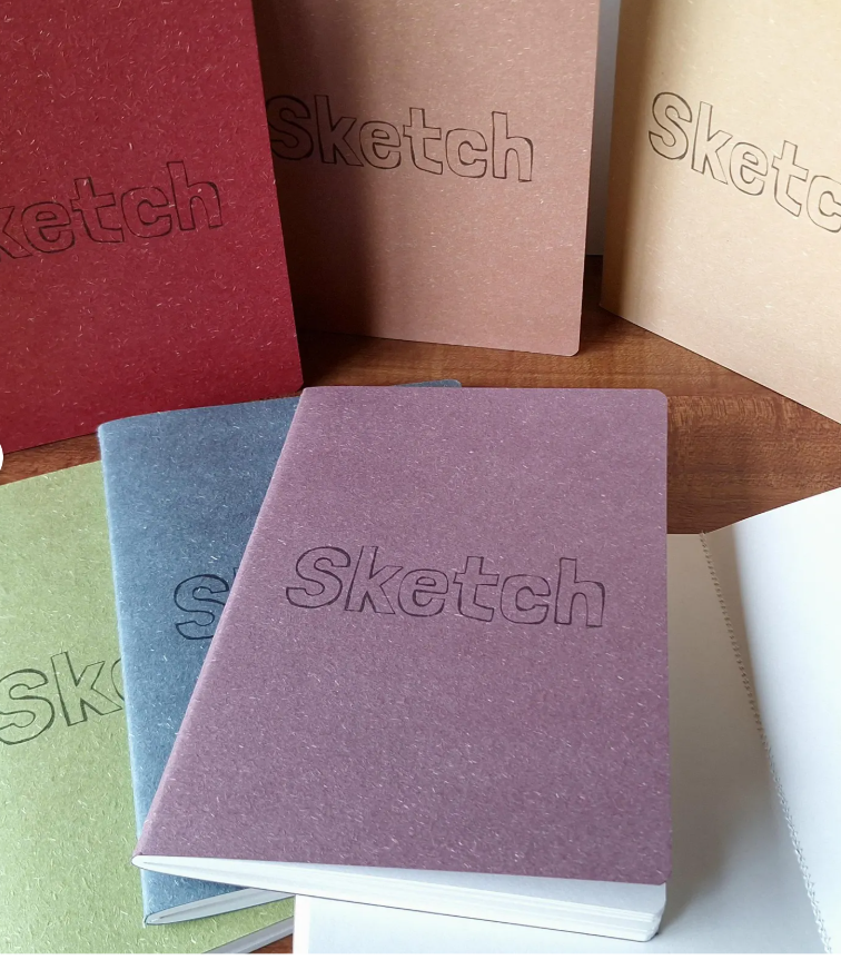Colourful sketchbooks with 'Sketch' printed on the cover.